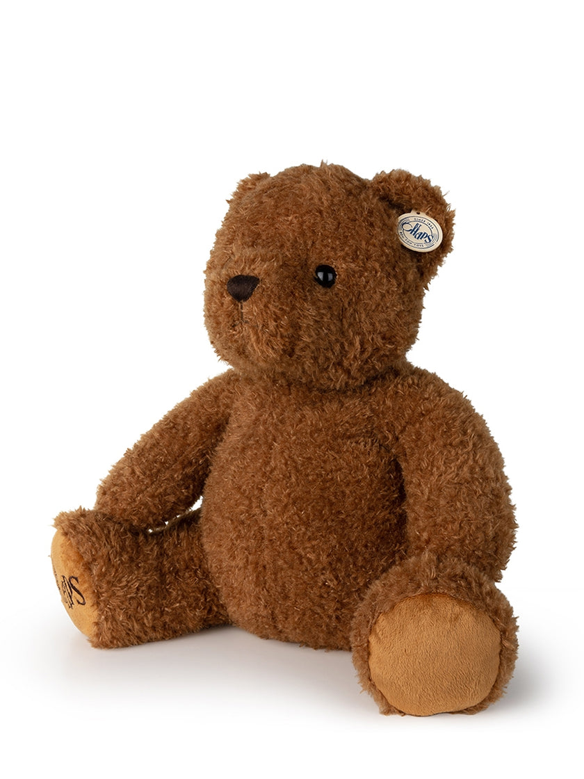 Brown plush teddy bear sitting.