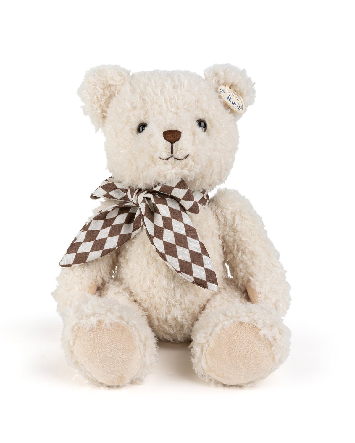 Stuffed teddy bear with checkered bow tie.