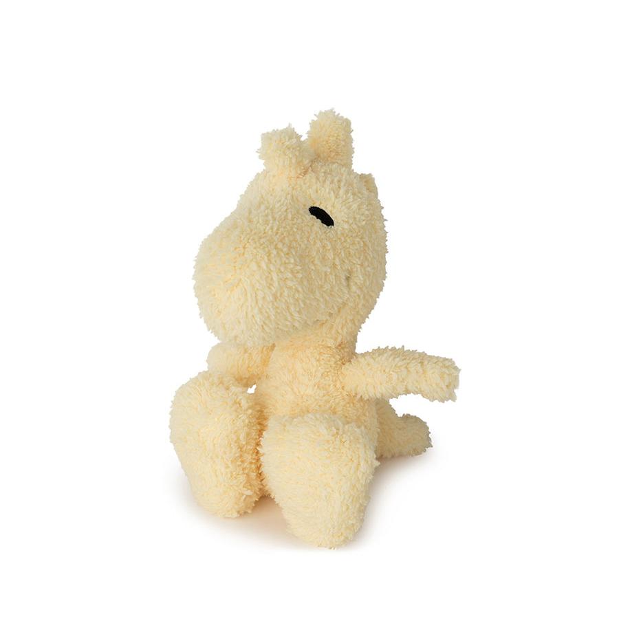 Stuffed hippopotamus plushie, cream-colored fur, sitting.