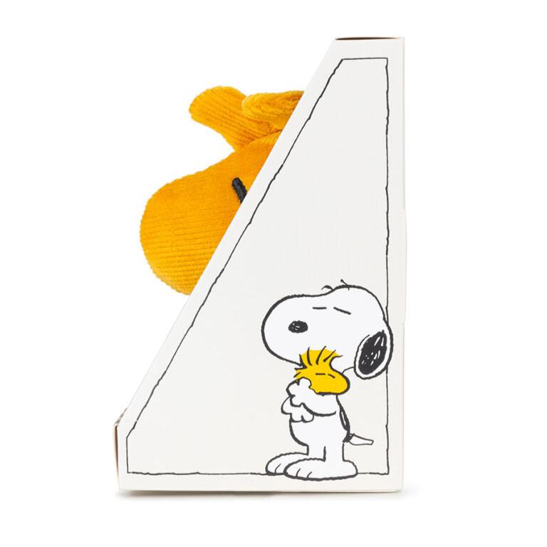 Snoopy plush toy in box.