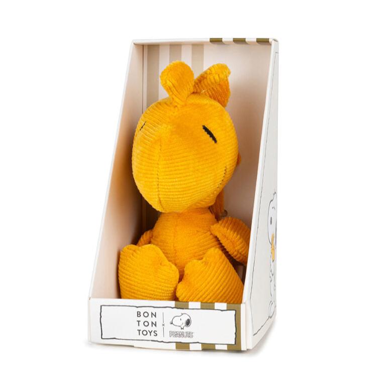 Yellow stuffed Woodstock toy in box.