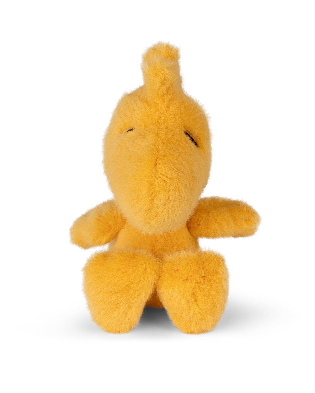Yellow stuffed animal toy with small black stitched eyes.