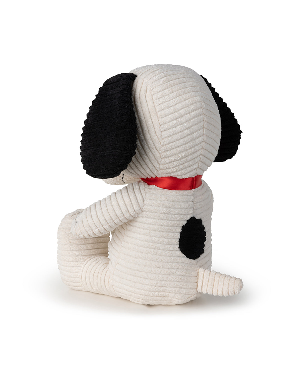 Back view of a white corduroy Snoopy plush with black ears and a red collar.