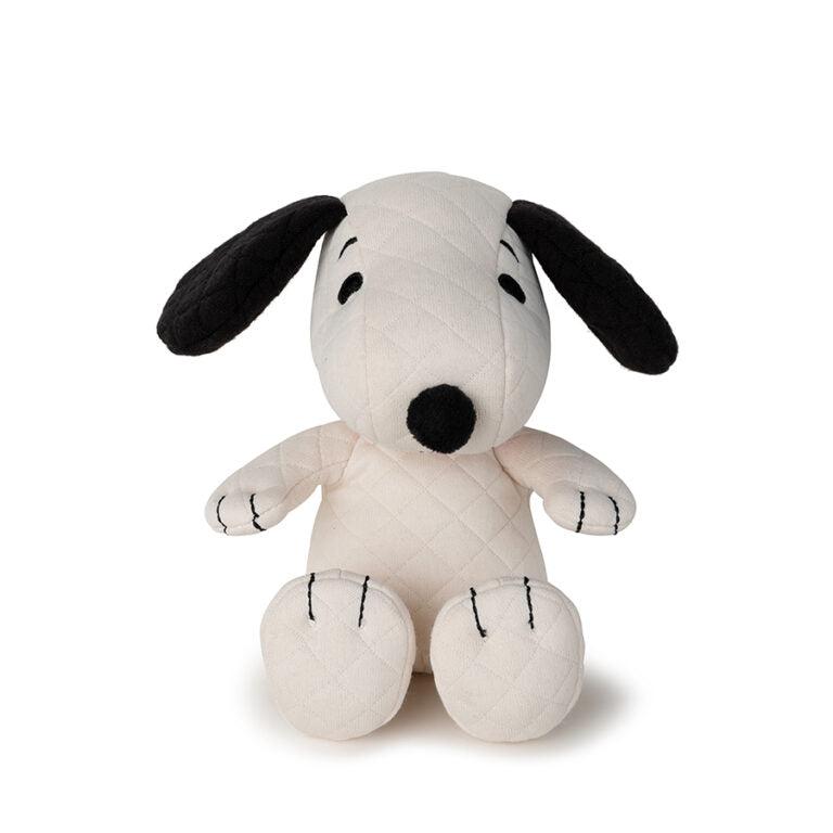 Stuffed Snoopy toy with quilted fabric.