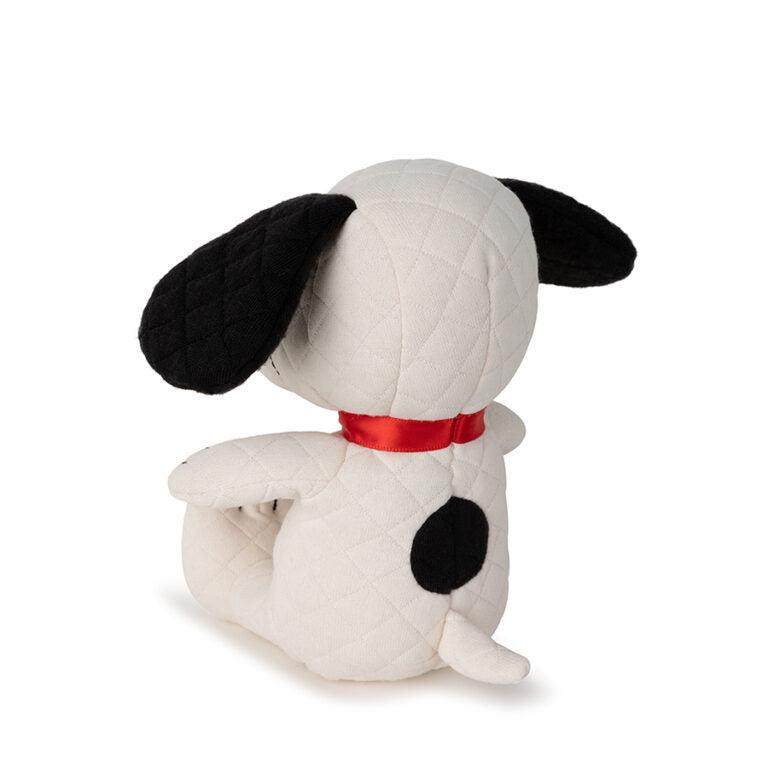 A plush Snoopy toy with black ears, a red collar, and a black spot on its back.