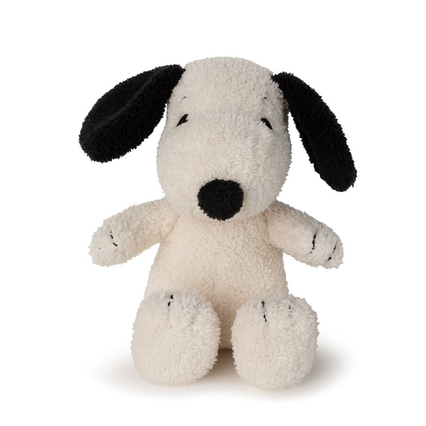 Stuffed Snoopy dog with black ears and nose.