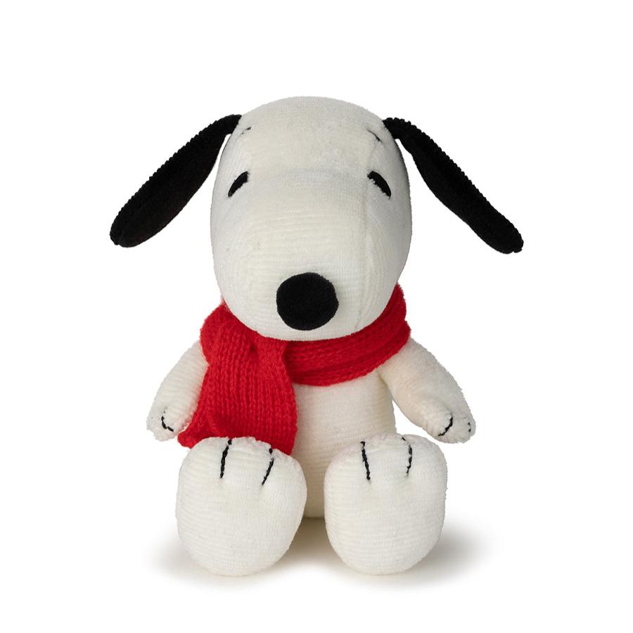Stuffed white Snoopy wearing a red scarf.