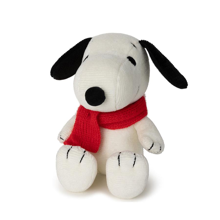 Stuffed Snoopy toy wearing a red scarf.