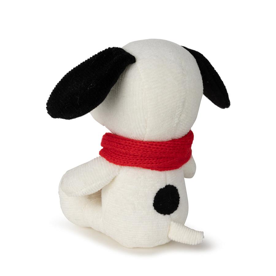 Back of white plush dog wearing a red scarf.