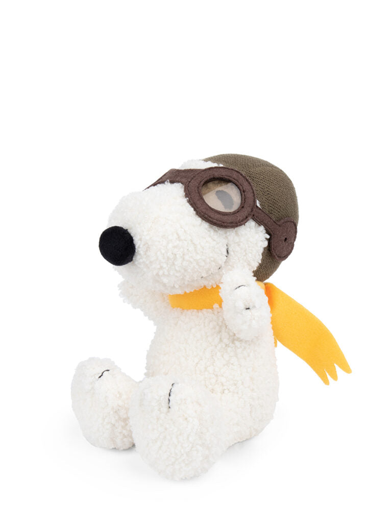 Stuffed Snoopy dog toy wearing an aviator helmet and yellow scarf.