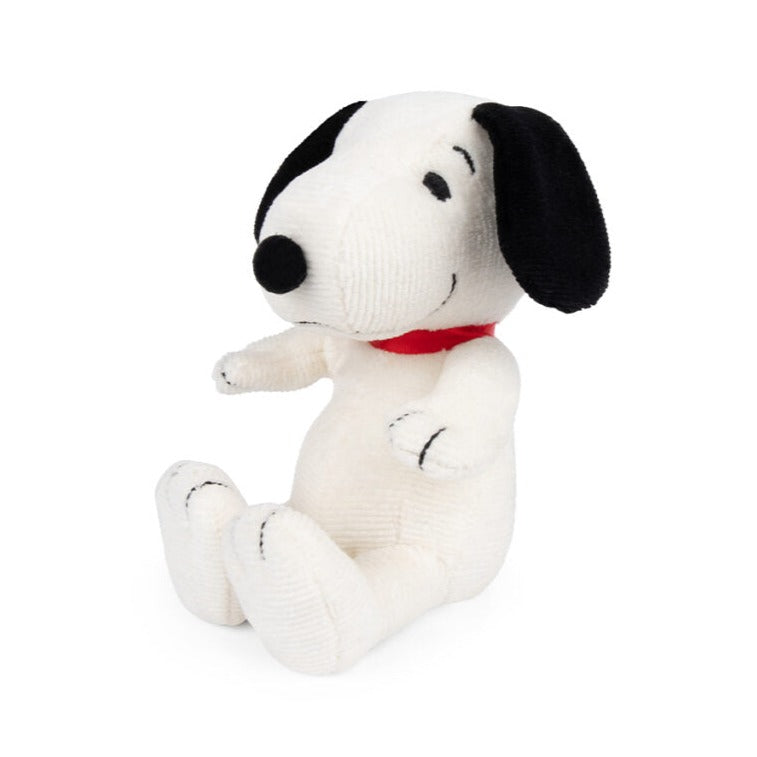 Stuffed Snoopy toy wearing a red collar.