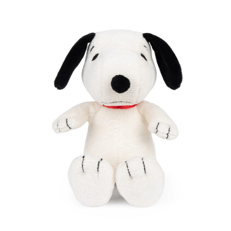 Stuffed Snoopy dog toy, cream-colored with black ears and nose, red collar.