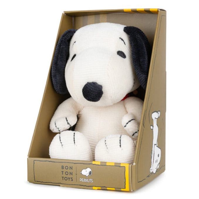 Snoopy plush toy in a cardboard box.