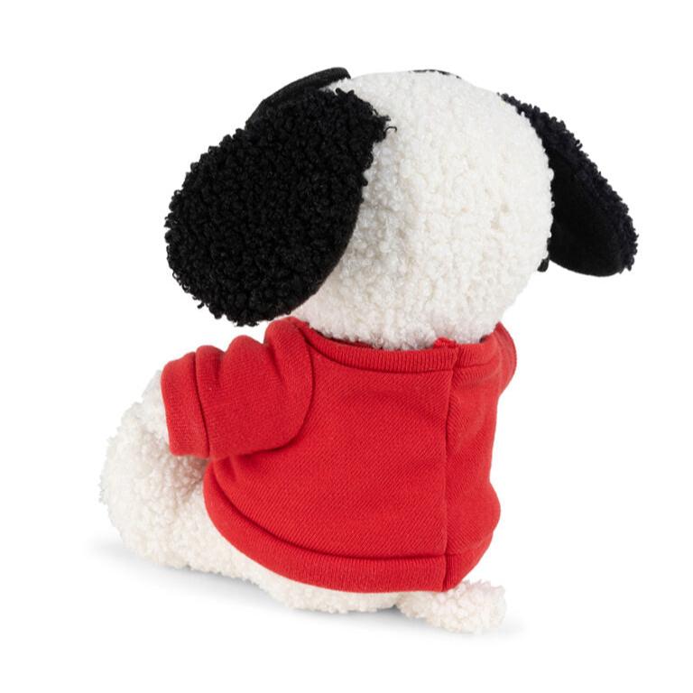 Rear view of a stuffed Snoopy dog wearing a red sweater.