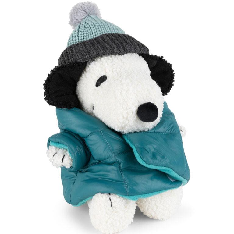 Stuffed Snoopy toy wearing a teal puffer jacket and a gray and teal knitted hat.