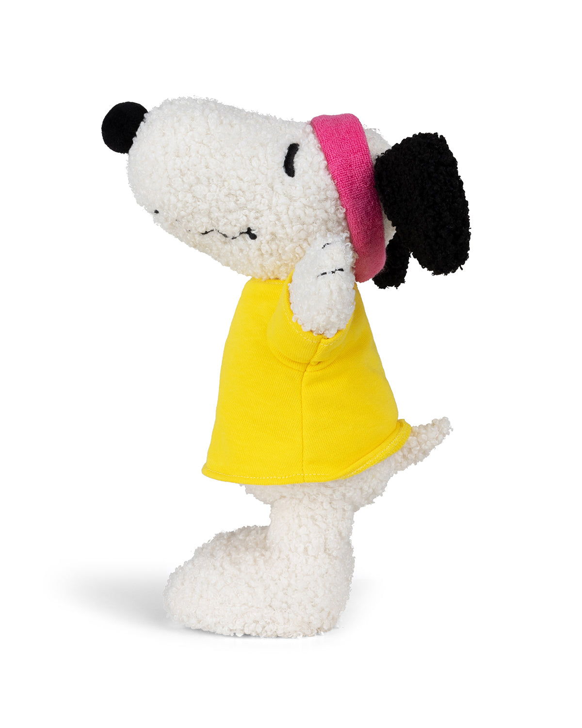 Plush Snoopy toy in yellow shirt and pink headband.
