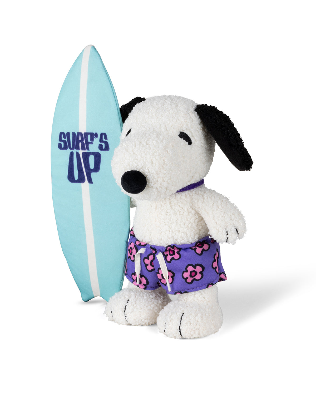 Stuffed Snoopy toy wearing purple floral swimming trunks and holding a blue surfboard.
