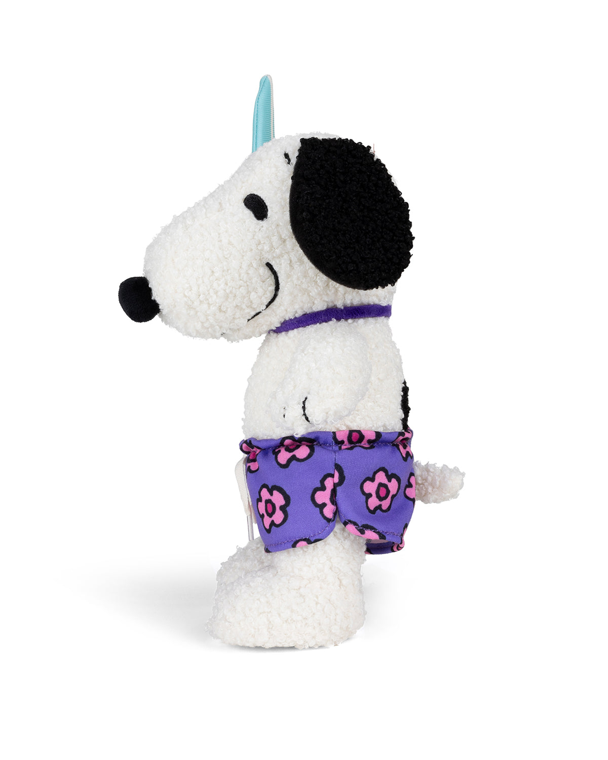 Stuffed Snoopy dog toy in purple flower-print shorts.