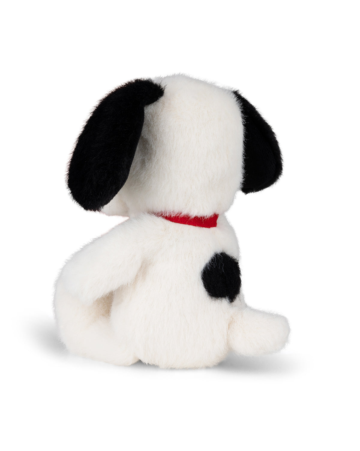 White plush dog toy with black ears and a red collar, viewed from the back.
