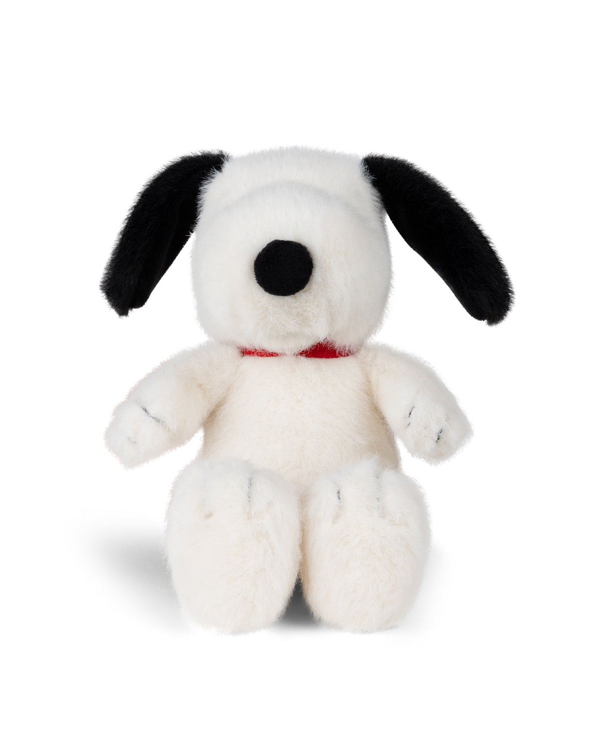 Stuffed white dog with black ears and nose, wearing a red collar.