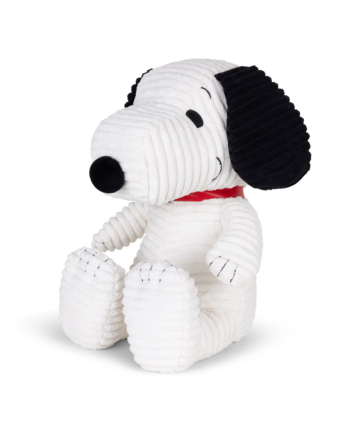 Plush toy resembling a black and white dog with a red collar on a white background