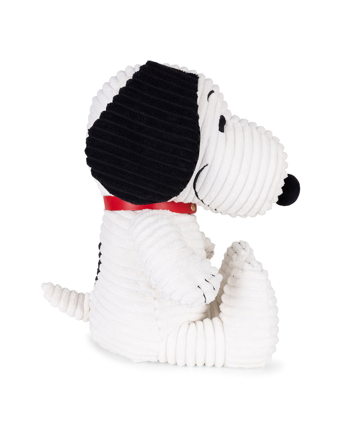 White plush dog toy with black ears and red bow tie on a white background