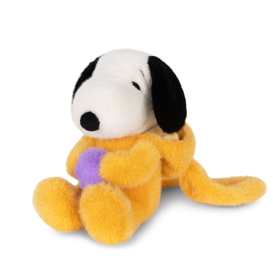 Plush toy resembling a dog with a purple heart on a white background