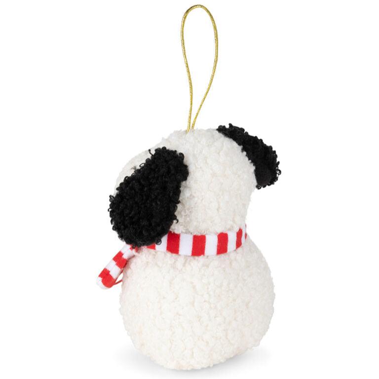 Stuffed, white dog with black ears, red and white striped scarf, and gold hanging loop.