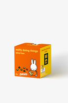 Orange and yellow blind box packaging for 'miffy doing things' by Smoko on a white background