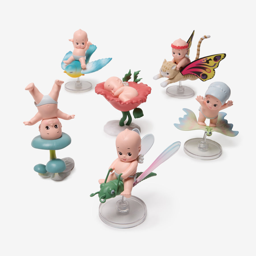 Set of small figurines on stands with a white background
