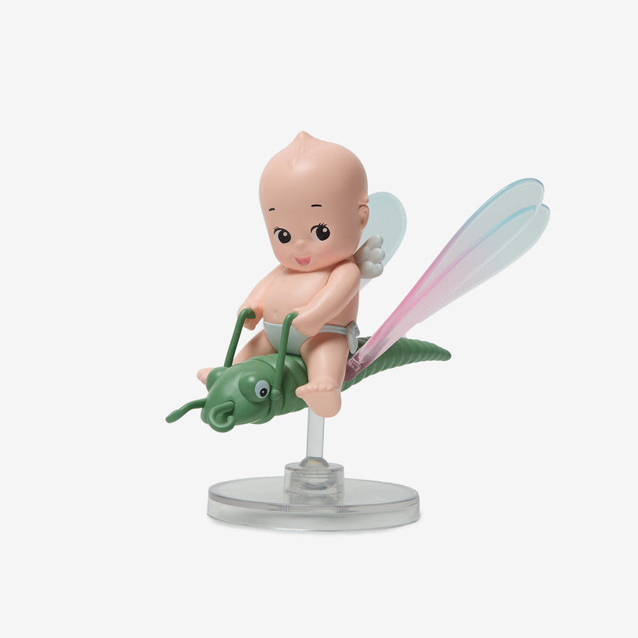 Figurine of a baby on a grasshopper with fairy wings on a white background