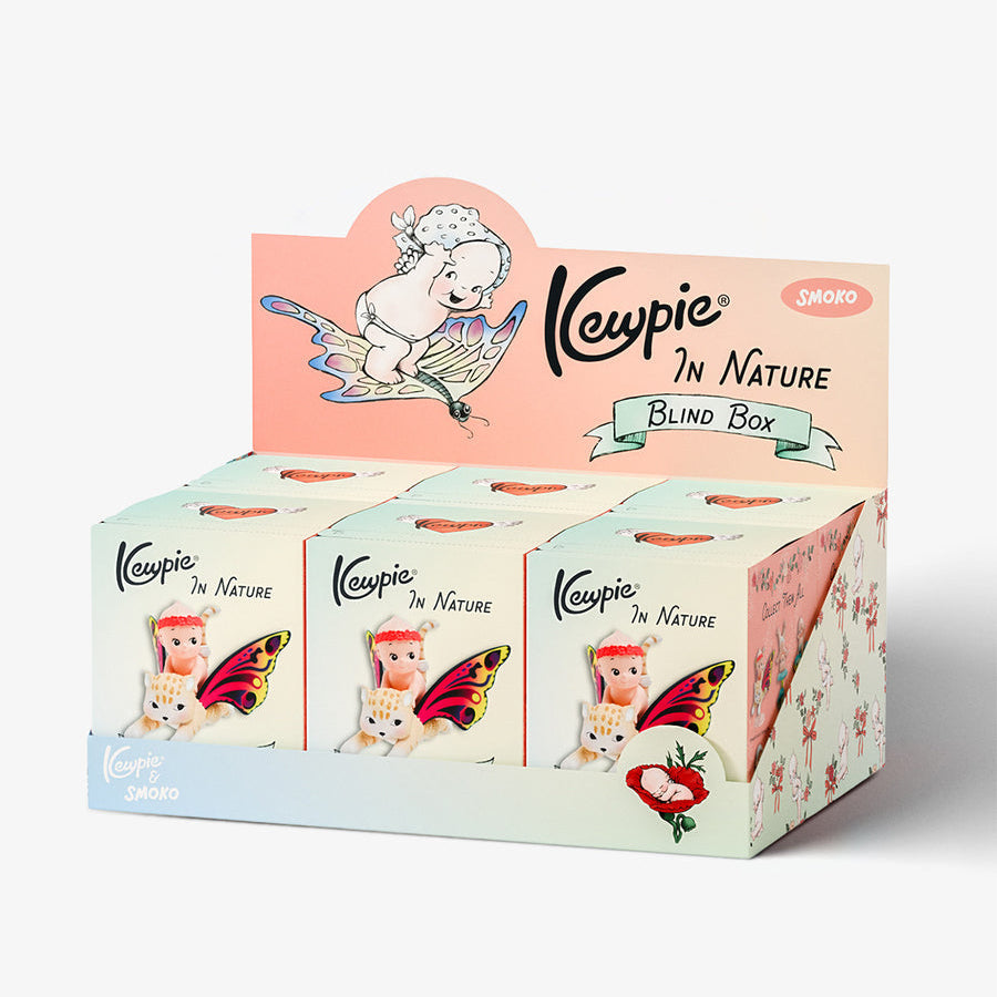 Kewpie In Nature Blind Box display box containing four individual boxes, decorated with cute cartoon illustrations of a white dog on a leaf, a butterfly, a cat, and a strawberry, on a clean white background.