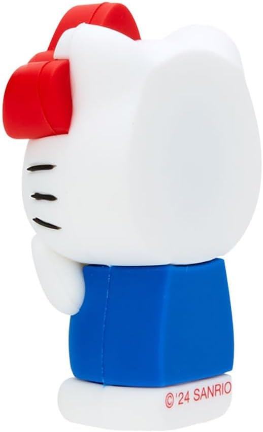 Back view of a white Hello Kitty figurine with a red bow and a blue dress.