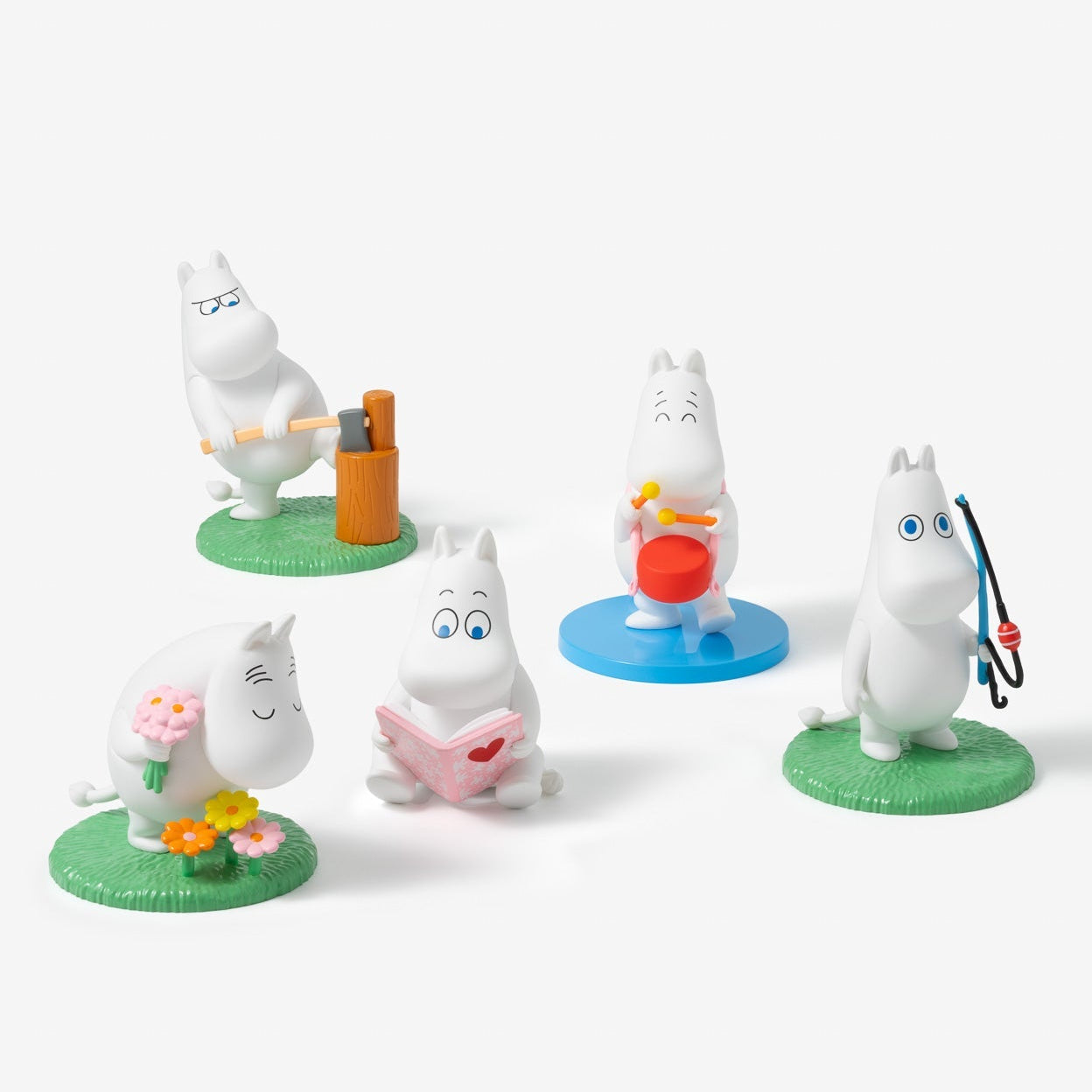 Set of Moomin figurines on a white background