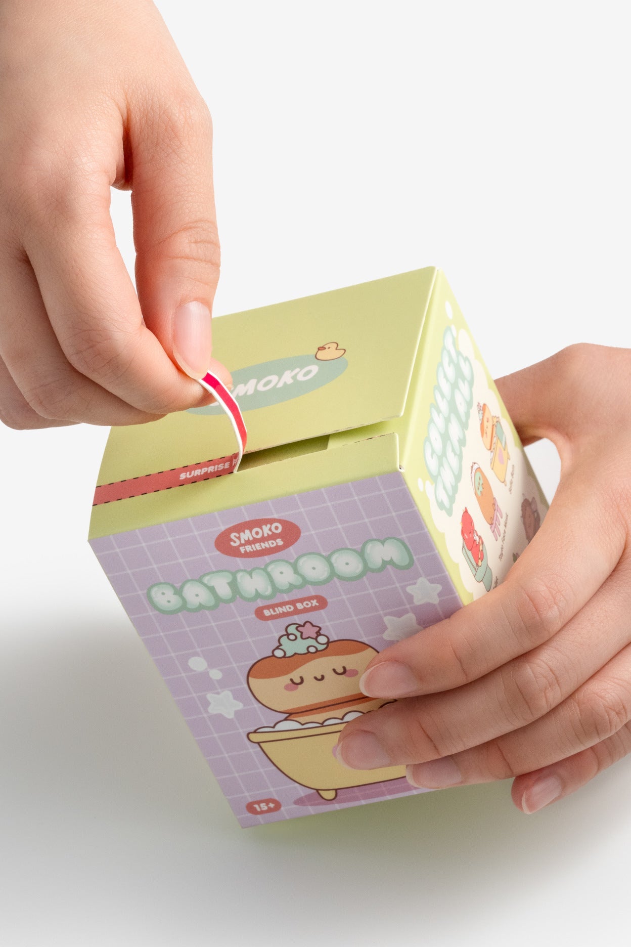 Hands opening a small box with a cute illustration of a bath tub on a white background