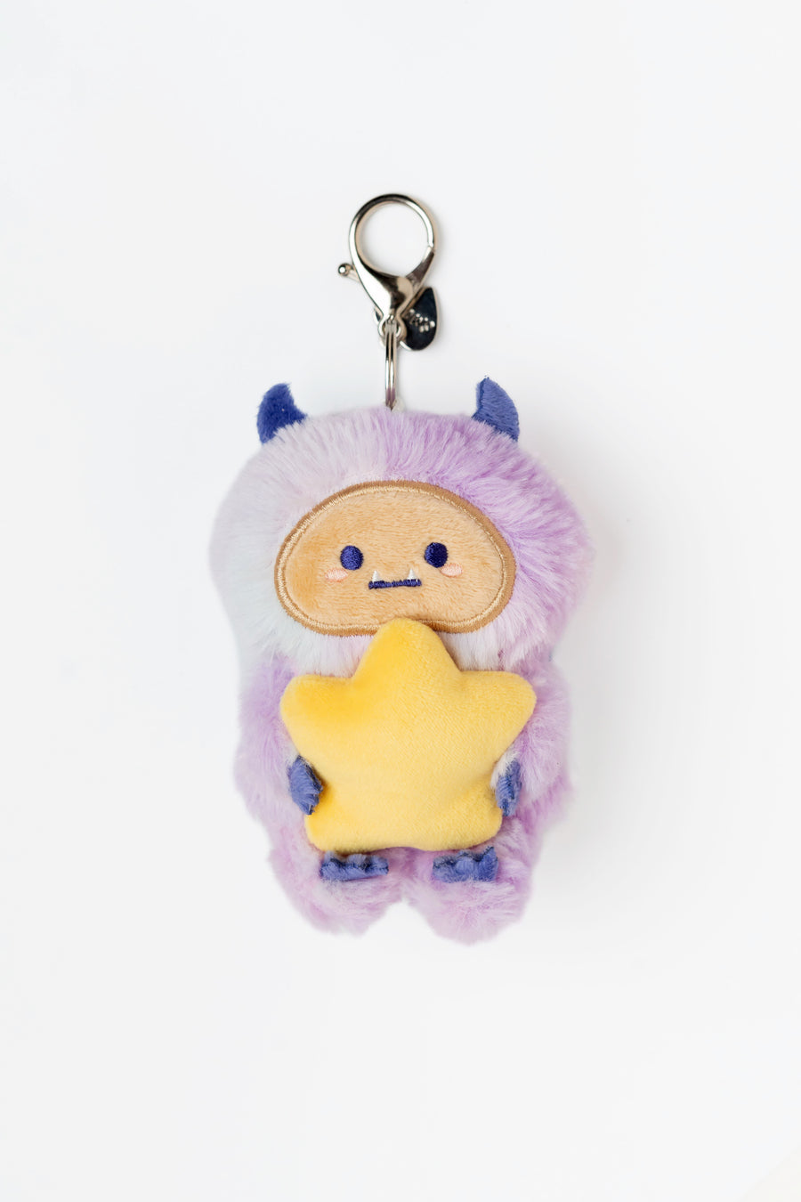 Plush keychain with a star-shaped body and purple hair on a white background