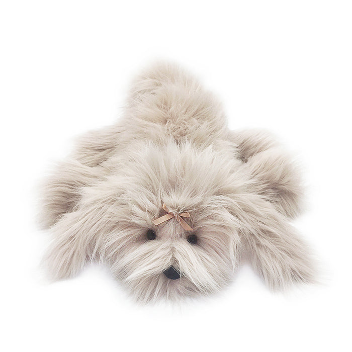 Fluffy beige stuffed dog toy with pink bow.