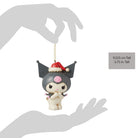 Gray figurine of Kuromi with a red Santa hat held in a hand.