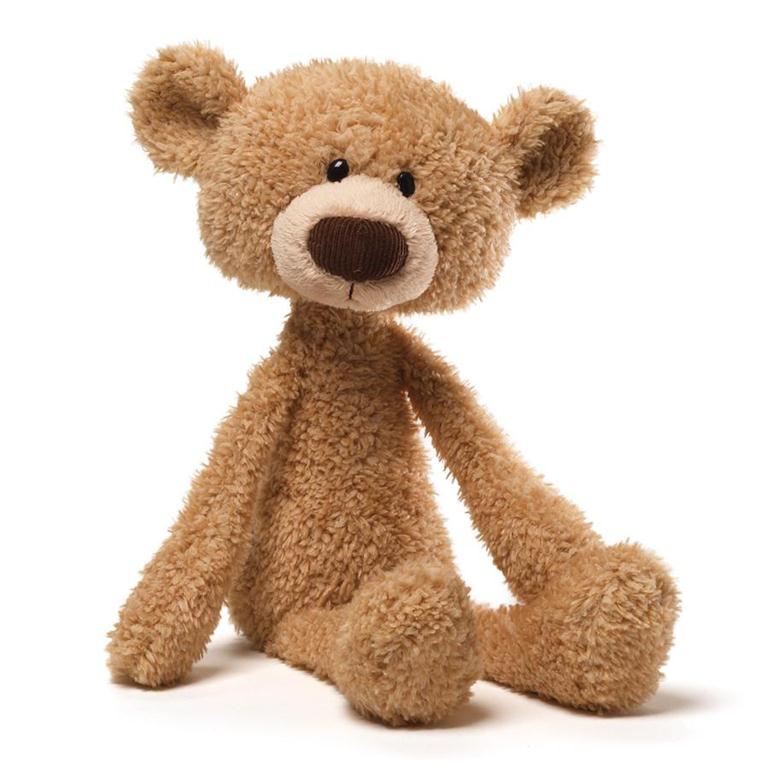 Tan stuffed teddy bear sitting on a white background.