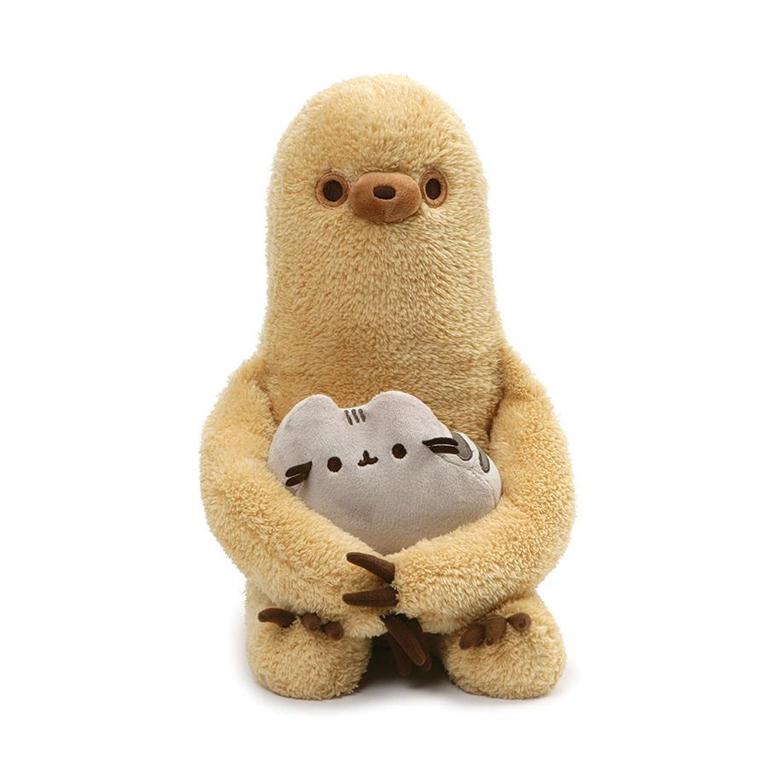 A stuffed, light brown sloth holding a gray Pusheen cat plush.