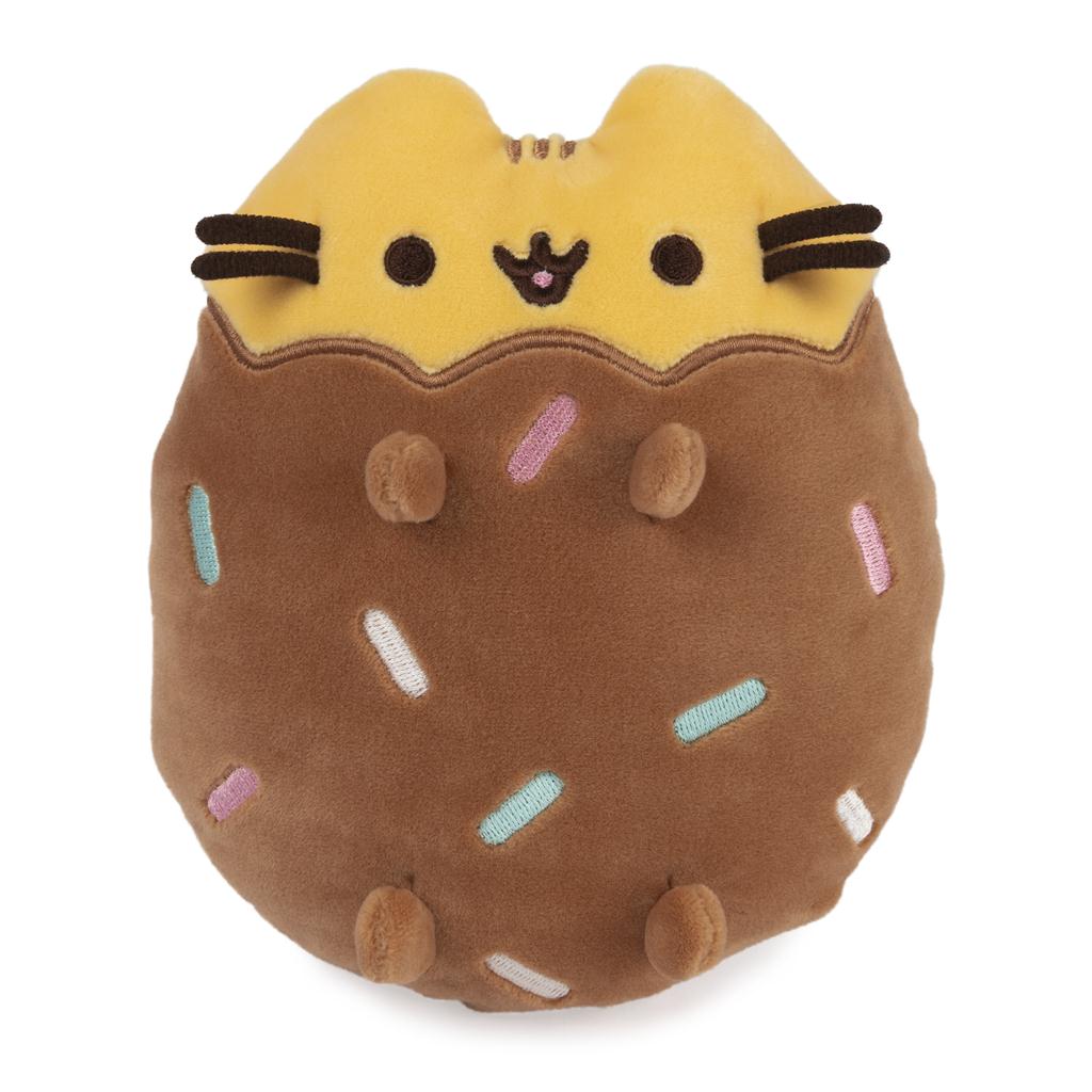 Pusheen plush toy in donut shape with sprinkles.