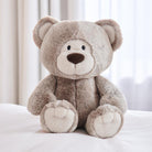 Plush teddy bear on a white surface with a neutral background