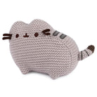 Grey knitted cat plush toy.