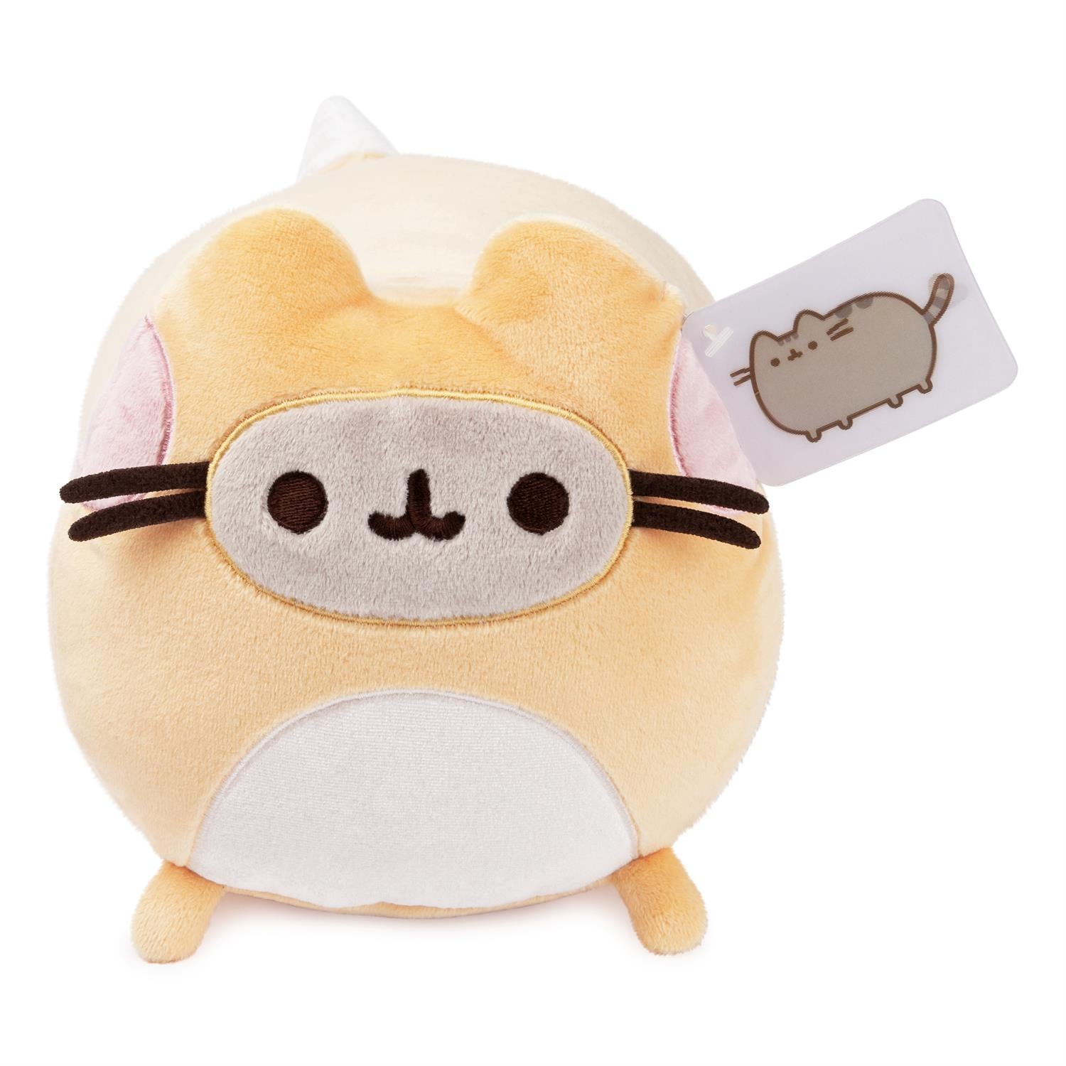 Pusheen plush toy wearing a sleep mask, with a tag.