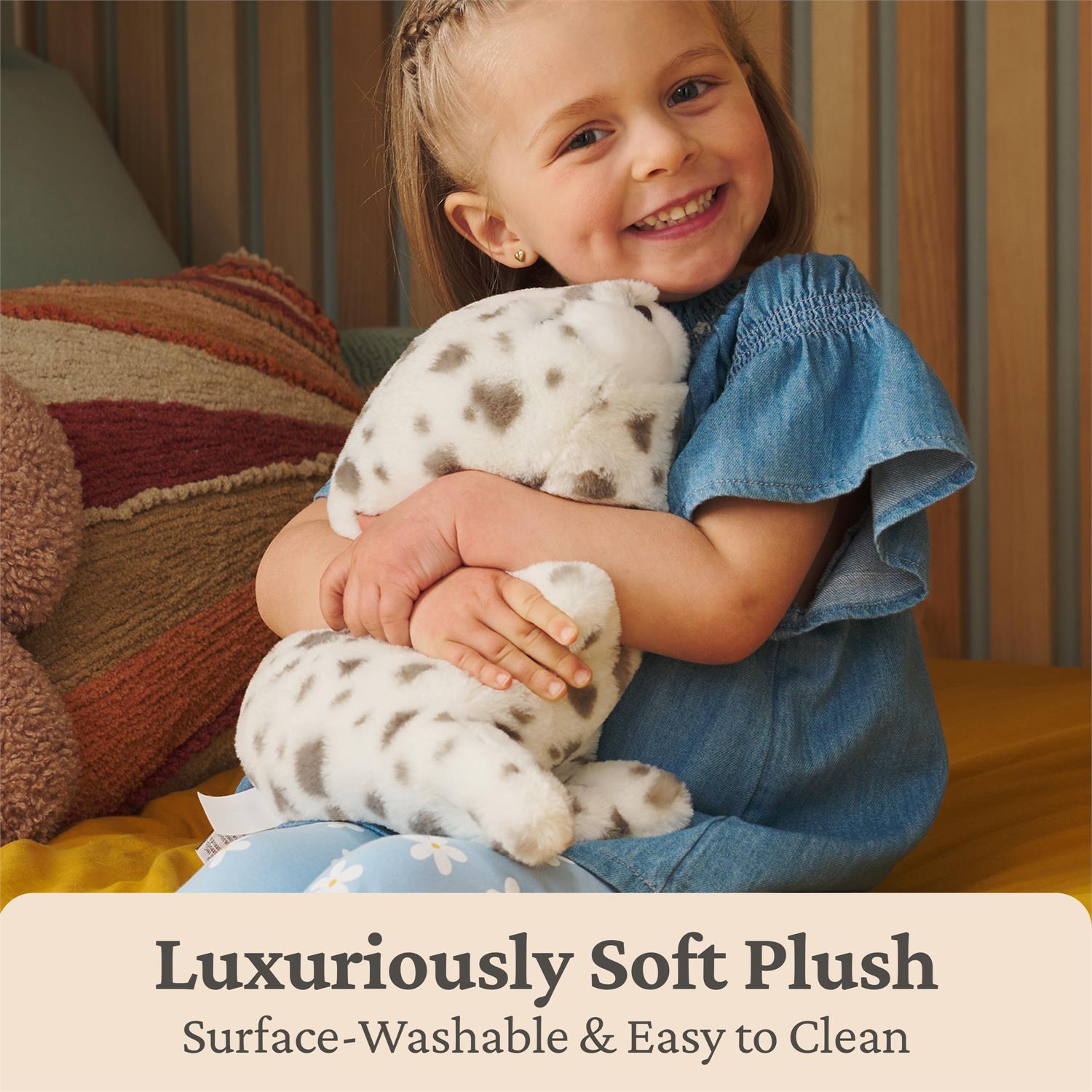 Child holding a plush toy with text about softness and ease of care.