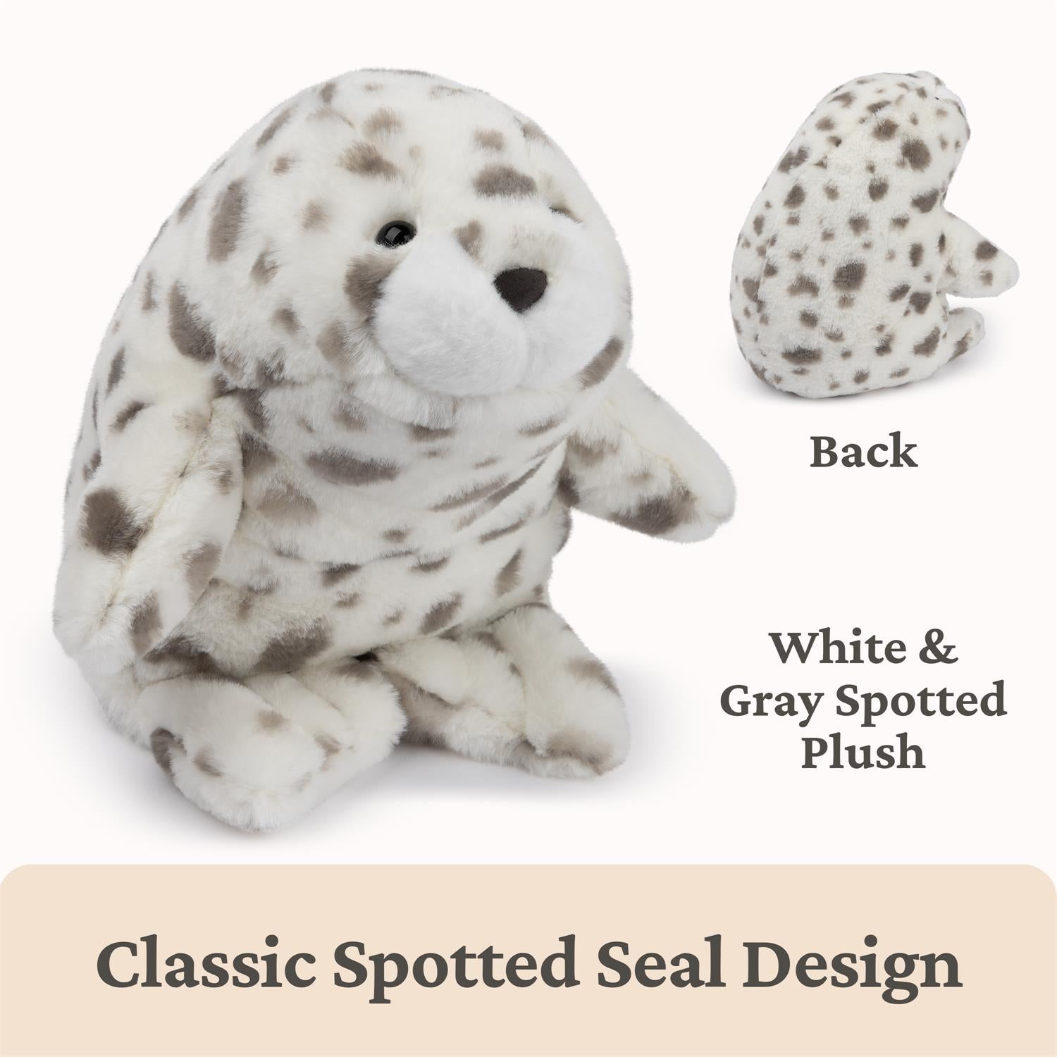White and gray spotted plush seal toy with back view on a beige background