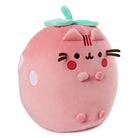 Pink strawberry-shaped cat plush toy with light green leaves.