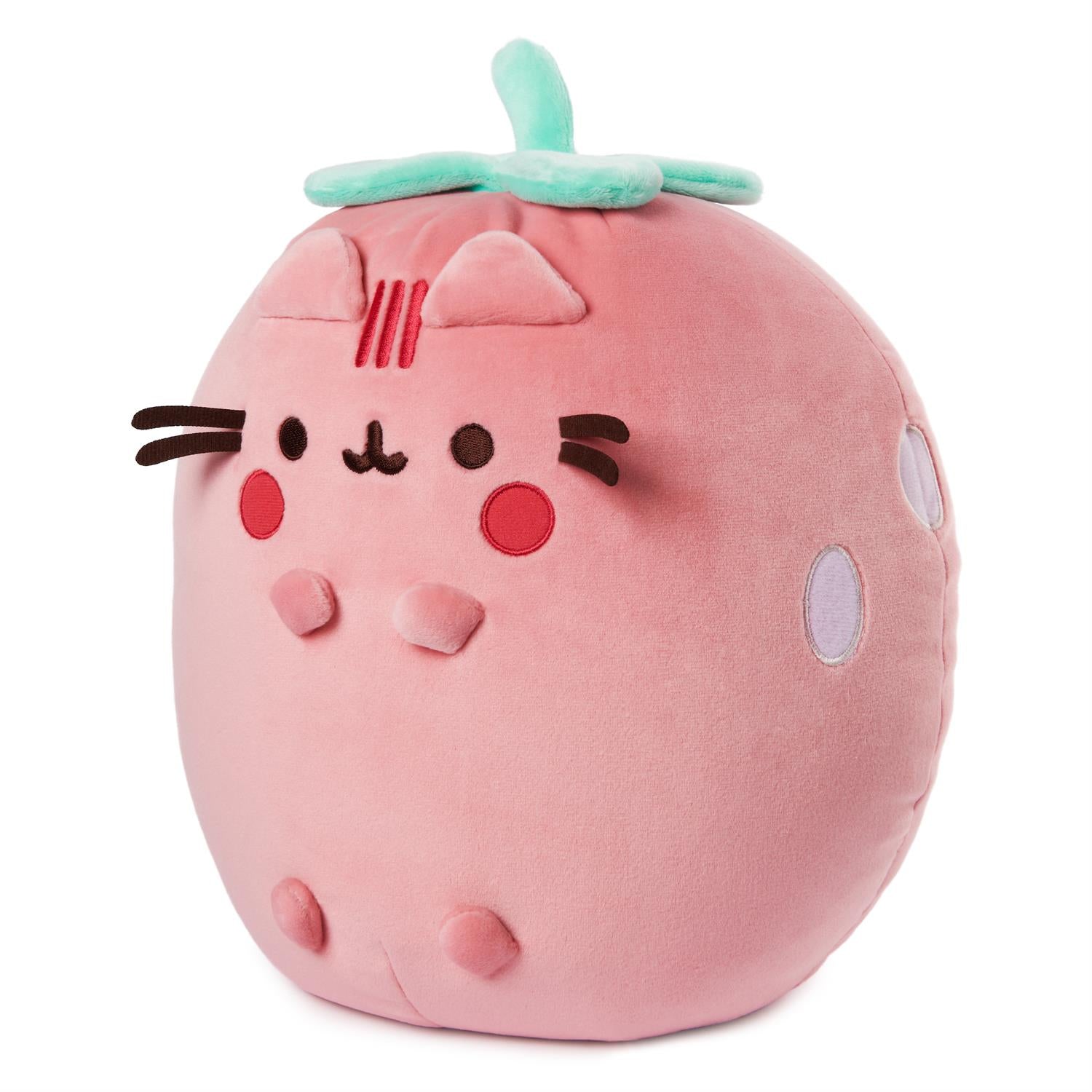 Pink strawberry cat plushie.