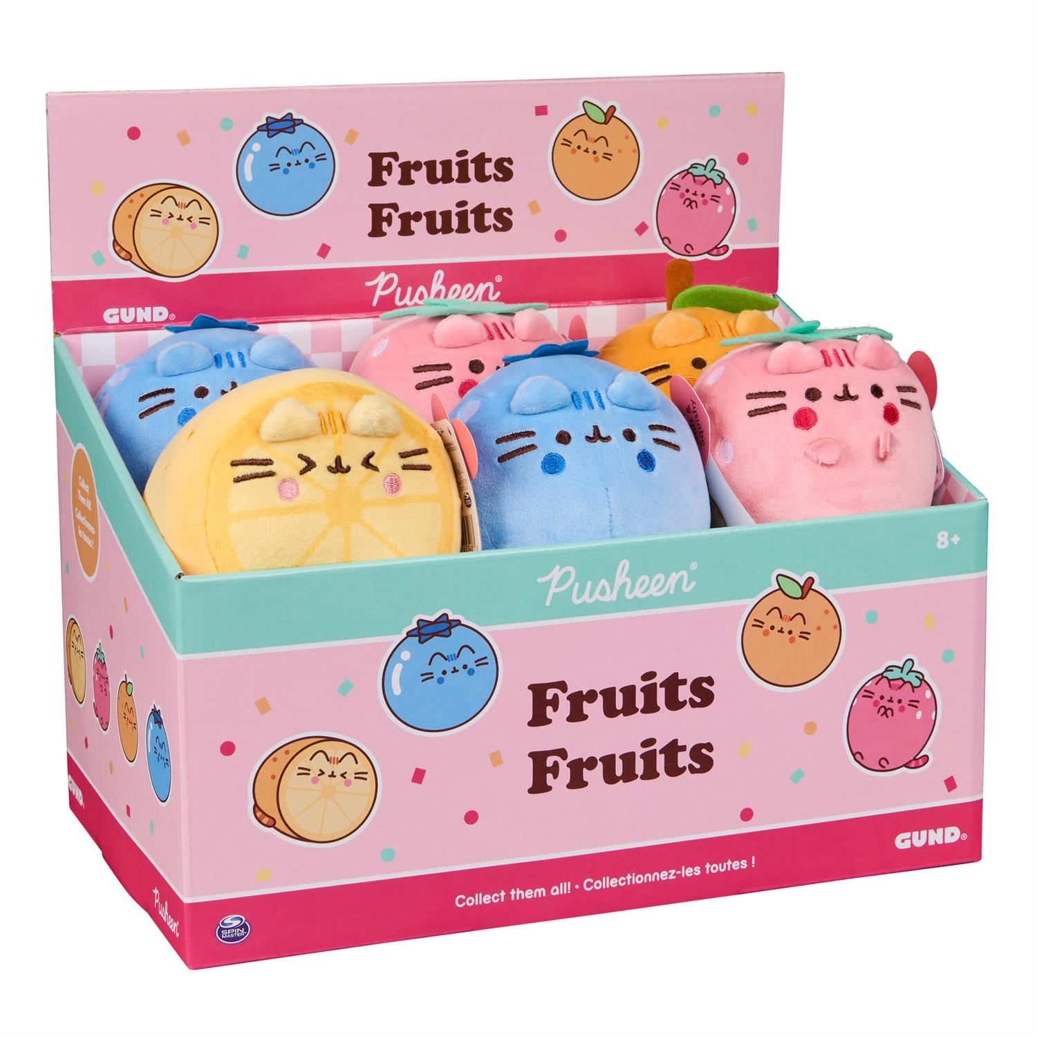 Display of Pusheen plush toys shaped like fruit in a pink and teal box.