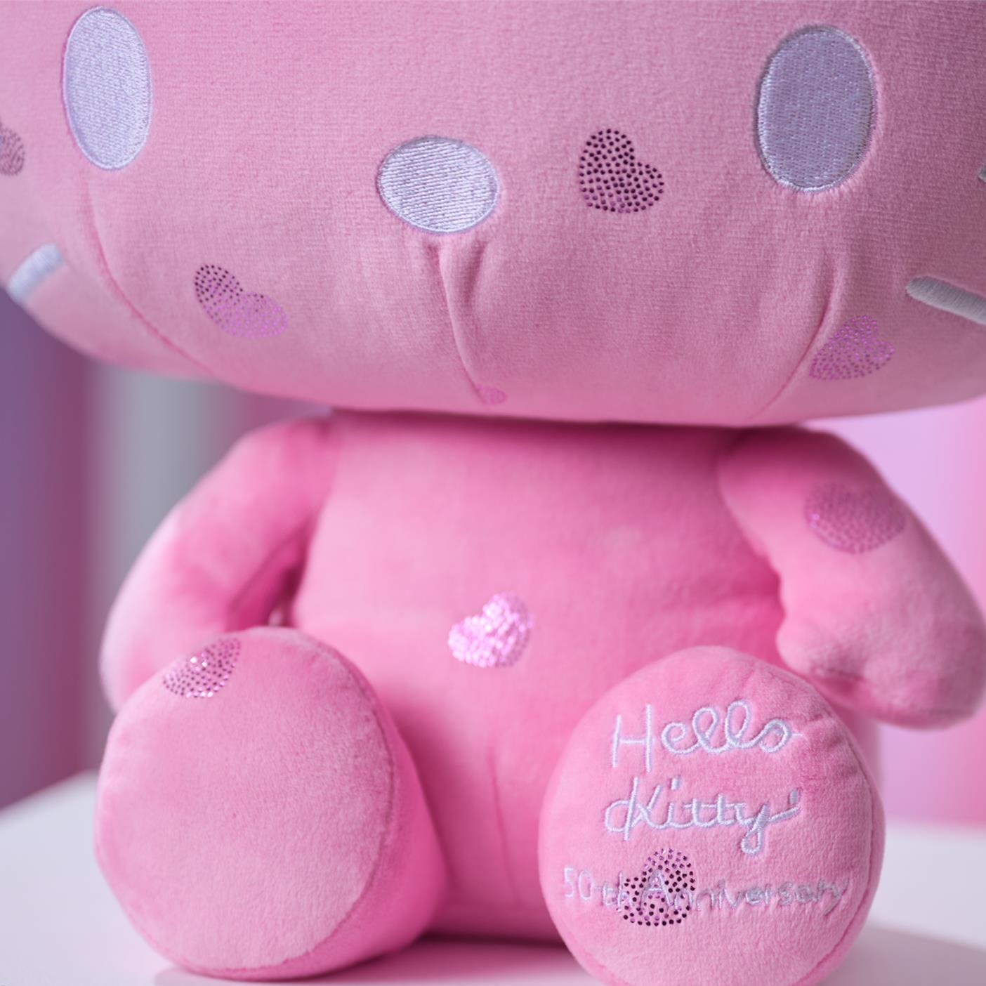 Close-up of a pink Hello Kitty 50th anniversary plush toy.